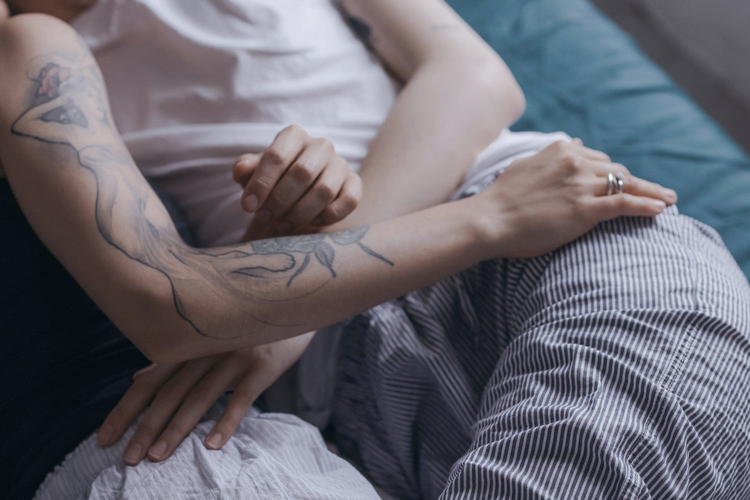 Lesbian couple touching each other in bed